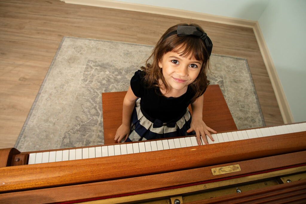 happy young piano student at grand piano